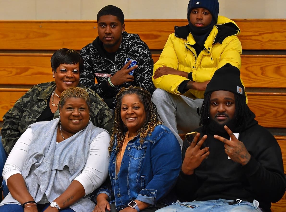 Chattanooga Strike fans and family sitting together on wooden gym bleachers at a home game